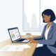 Instant business loan UK guide showing a British entrepreneur reviewing digital commercial lending options on laptop with pound sterling finance charts
